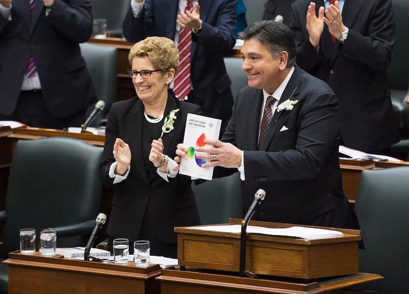 Ontario Finance Minister Charles Sousa, right, delivers the Ontario 2016 budget next to Premier Kathleen Wynne, left, at Queen's Park in Toronto on Thursday, February 25, 2016. (Nathan Denette/CP)