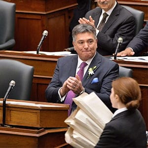 Ontario Finance Minister Charles Sousa and Premier Kathleen Wynne applaud as copies of the provincial budget are brought into the legislature at Queen's Park in Toronto on Thursday, April 23, 2015. (Nathan Denette/CP)