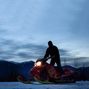 Clint Pelletier, of Edmonton, Alta., is silhouetted while loading his snowmobile onto a trailer after snowmobiling with his wife at Mount Renshaw near McBride, B.C., on Saturday January 30, 2016. Five snowmobilers died Friday in a major avalanche in the Renshaw area east of McBride. (DARRYL DYCK/CP)