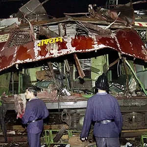In this July 11, 2006 file photo, fire officers stand near a train coach destroyed by a bomb blast at Matunga railway station in Mumbai, India. An Indian court on Wednesday, Sept. 30, 2015 sentenced five suspected Islamic militants to death and gave seven others life in prison for bombing attacks nine years ago on seven Mumbai commuter trains that killed 188 people and wounded more than 800. (Aijaz Rahi/AP)