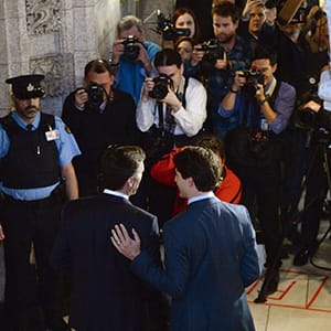 Prime Minister Justin Trudeau places his hand on the back of Minister of Finance Bill Morneau as he accompanies him in his way to deliver the federal budget in the House of Commons on Parliament Hill in Ottawa on Tuesday, March 22, 2016. (Sean Kilpatrick/CP)