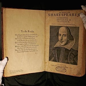 A Sotheby's employee handles a copy of William Shakespeare, The First Folio 1623 on July 7, 2006 in London, England. The most important book in English Literature, the First Folio edition of Shakespeare's plays (1623), will be offered in Sotheby's sale of English Literature & History on July 13th, and is estimated to fetch GBP 2.5-3.5 million. (Scott Barbour/Getty Images)