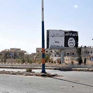 A billboard (R) belonging to the Islamic State fighters erected along a road, is pictured after forces loyal to Syria's President Bashar al-Assad recaptured Palmyra city, in Homs Governorate on March 27, 2016. (SANA/Reuters) ATTENTION EDITORS - THIS PICTURE WAS PROVIDED BY A THIRD PARTY. REUTERS IS UNABLE TO INDEPENDENTLY VERIFY THE AUTHENTICITY, CONTENT, LOCATION OR DATE OF THIS IMAGE.