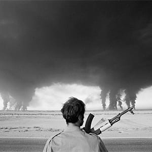 September 1980, Abadan, Iran --- An Iraqi soldier watches as the Iranian Abadan refinery, located near the Iraqi border, burns. The Abadan oil refinery was under constant fire from the Iraqi air force during the Iran-Iraq conflict. (Henri Bureau/Sygma/Corbis)