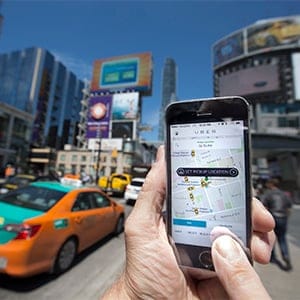 TORONTO, ON - MAY 14 -Photographed at Dundas Square, Toronto, Uber taxi service is a new way to travel around the city. Request and payment are all made using an app. (Bernard Weil/Toronto Star via Getty Images)