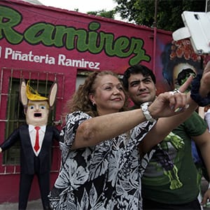 Mexican artisan Dalton Ramirez and a customer pose for a selfie in front of a pinata depicting U.S. Republican presidential candidate Donald Trump outside his workshop in Reynosa, Mexico, June 23, 2015. In the Mexican border city of Reynosa, Dalton Ramirez works at his family's pinata shop where they create a variety of paper mache figures to be filled with treats and broken open with sticks on birthdays and holidays. (Daniel Becerril/Reuters)