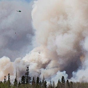 A helicopter battles a wildfire in Fort McMurray Alta, on Wednesday May 4, 2016. The wildfire has already torched 1,600 structures in the evacuated oil hub of Fort McMurray and is poised to renew its attack in another day of scorching heat and strong winds. (Jason franson/CP)