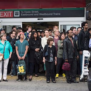 Crowds of people line up to ride shuttle buses going westbound at Keele Station in Toronto on Tuesday, Sept. 30, 2014. The westbound train to St. George station is closed due to track-related issues. (Hannah Yoon/CP)