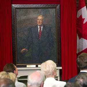Former prime minister Paul Martin gestures to his official portrait as he speaks following its unveiling during a ceremony on Parliament Hill in Ottawa, Wednesday May 11, 2016. THE CANADIAN PRESS/Adrian Wyld