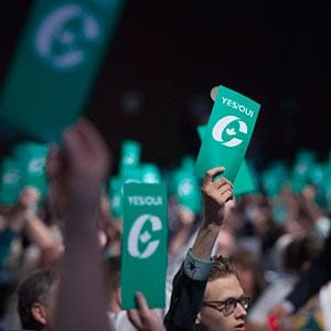 Delegates raise their yes vote cards to change the wording of the traditional definition of marriage in the conservative policies at the Conservative Party of Canada convention in Vancouver, Saturday, May 28, 2016. (Jonathan Hayward/CP)