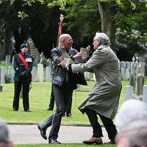 Canadian Ambassador to Ireland Kevin Vickers, right, wrestles with a protester during a State ceremony to remember the British soldiers who died during the Easter Rising at Grangegorman Military Cemetery, Dublin Thursday May 26, 2016. Vickers helped subdue a demonstrator who began chanting “insult” at the service commemorating more than 100 British soldiers killed trying to suppress the Easter Rising a century ago. (Brian Lawless/AP)
