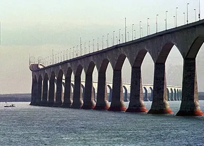 The Confederation Bridge connecting Prince Edward Island to New Brunswick dwarfs a fishing boat on the Northumberland Strait on Tuesday. A three-day festival is planned to celebrate the opening of the link that will see public traffic on Sunday. (Andrew Vaughan/CP)