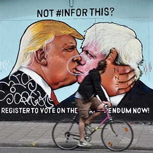 A cyclist takes a look at a painted image of former London Mayor Boris Johnson (R) and US Presidential candidate Donald Trump (L) in Stokes Croft in Bristol, Britain, 30 May 2016. Boris Johnson is supporting the Brexit campaign, ahead of a referendum on whether Britain should remain in or leave the EU on 23 June. (NEIL MUNNS/EPA/CP)