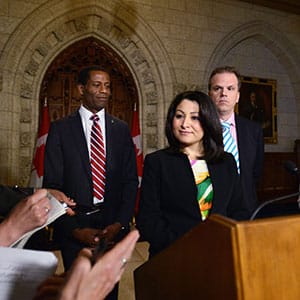 Minister of Democratic Institutions Maryam Monsef is joined by fellow MPs Mark Holland, right, and Greg Fergus as they speak to reporters in the foyer of the house of commons on Parliament Hill in Ottawa on Thursday, June 2, 2016. (Sean Kilpatrick/CP)