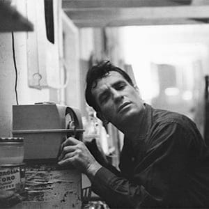 American Beat writer Jack Kerouac (1922 - 1969) leans closer to a radio to hear himself on a broadcast, 1959. (John Cohen/Getty Images)