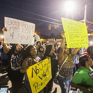 Protesters march to the convenience store where Alton Sterling was shot and killed, July 6, 2016 in Baton Rouge, Louisiana. Sterling was shot by a police officer in front of the Triple S Food Mart in Baton Rouge on Tuesday, July 5, leading the Department of Justice to open a civil rights investigation. (Mark Wallheiser/Getty Images)