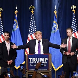 Presidential candidate Donald Trump speaks as his sons Donald Trump Jr. (left) and Eric Trump look on during a caucus night watch party at the Treasure Island Hotel & Casino on February 23, 2016 in Las Vegas, Nevada. (Ethan Miller/Getty Images)