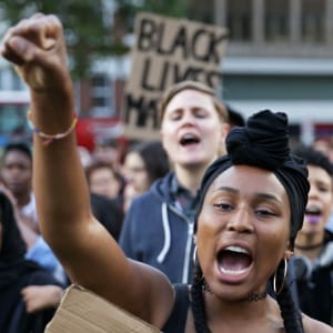 People chant and hold up with placards in Altab Ali Park in east London, as they attend a Black Lives Matter event, on August 5, 2016. (Daniel Leal-Olivas/Getty)