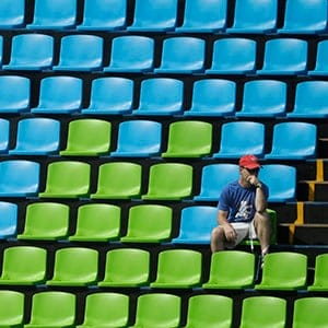 A fan sits surround by empty seats at the equestrian eventing dressage competition at the 2016 Summer Olympics in Rio de Janeiro, Brazil, Sunday, Aug. 7, 2016. (John Locher/AP)