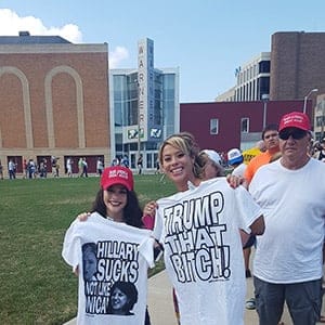 Two women show off their newly purchased t-shirts outside a Trump rally in Erie, Pennsylvania. (James McLeod)