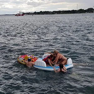 A Canadian Coast Guard ship tows floatation devices used by U.S. partiers to the Canadian side of the St. Clair River between Michigan and Ontario on August 21, 2016. About 1,500 Americans ended up in Canada after getting hit by strong wind and rain. (Canadian Coast Guard/Reuters)