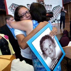 Bridget Tolley, whose mother Gladys was killed in 2001, is embraced after the announcement of the inquiry into Murdered and Missing Indigenous Women at the Museum of History. (Justin Tang/CP)