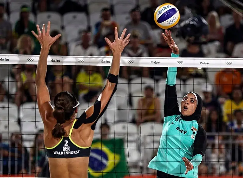 Doaa Elgobashy of Egypt (R) spikes the ball against Kira Walkenhorst of Germany (L) during the women's Beach Volleyball preliminary pool D game between in Rio on August 7. (ANTONIO LACERDA/EPA/CP)