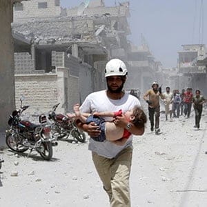 A civil defence member carries an injured girl at a site hit by airstrikes in the rebel-controlled area of Maaret al-Numan town in Idlib province, Syria June 2, 2016. (Khalil Ashawi/Reuters)