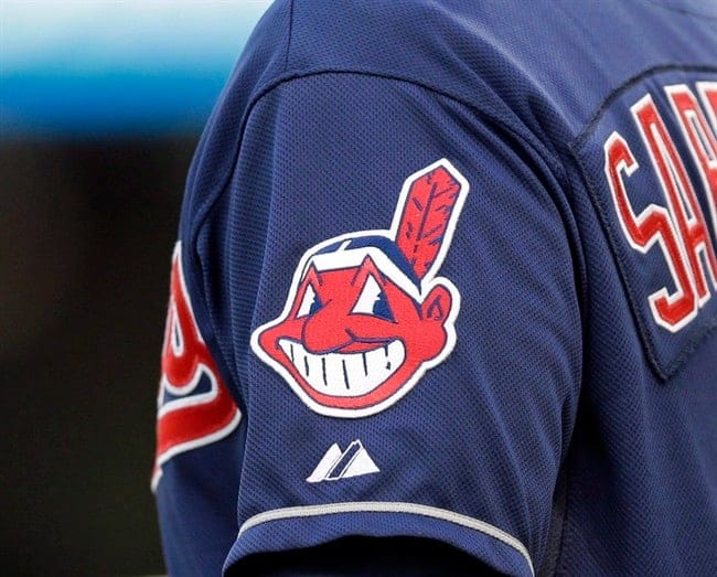 In this April 8, 2014 photo, the Cleveland Indians Chief Wahoo logo is shown on the uniform sleeve of third base coach Mike Sarbaugh during a baseball game against the San Diego Padres in Cleveland, Ohio. In this April 8, 2014 photo, the Cleveland Indians Chief Wahoo logo is shown on the uniform sleeve of third base coach Mike Sarbaugh during a baseball game against the San Diego Padres in Cleveland, Ohio. A Toronto court will hear arguments today on an attempt to bar the Cleveland Indians from using their team name and logo in Ontario.The legal challenge by indigenous activist Douglas Cardinal comes on the same day that the baseball team takes on the Toronto Blue Jays in Game 3 of the American League Championship Series. (Mark Duncan/CP)