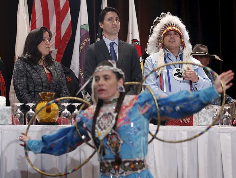 Canada's Prime Minister Justin Trudeau (C) stands with Justice Minister Jody Wilson-Raybould (L) and Assembly of First Nations National Chief Perry Bellegarde during an opening ceremony at the Assembly of First Nations Special Chiefs Assembly in Gatineau, Canada, December 8, 2015. (Chris Wattie/Reuters)