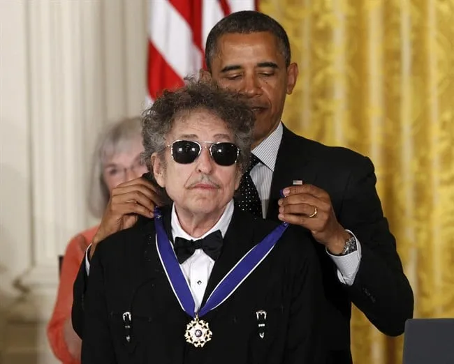 In this May 29, 2012, file photo, President Barack Obama presents rock legend Bob Dylan with a Medal of Freedom during a ceremony at the White House in Washington. (AP Photo/Charles Dharapak, File)