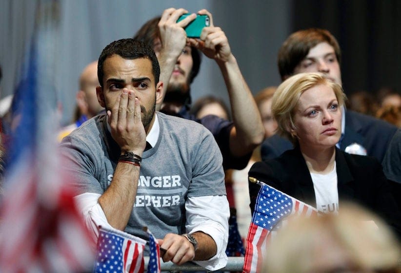 Hillary Clinton supporters react as results come in at an election night party for the Democratic presidential candidate at the Jacob K. Javits Convention Center in New York, late on Tuesday, Nov. 8, 2016. (Vernon Bryant/The Dallas Morning News via AP)