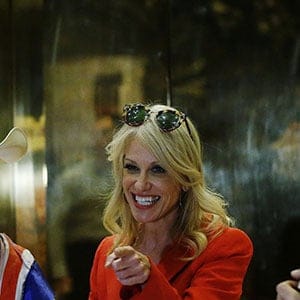 Kellyanne Conway, campaign manager and senior advisor to the Trump Presidential Transition Team, converses with "Naked Cowboy" themed street performers in the lobby at Trump Tower in New York, U.S., November 28, 2016. (Lucas Jackson/Reuters)