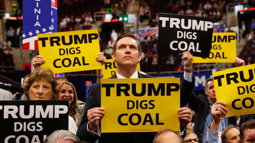 Delegates from West Virginia hold signs supporting coal on the second day of the Republican National Convention in Cleveland, Ohio, U.S. July 19, 2016. REUTERS/Aaron P. Bernstein/File Photo