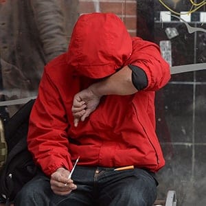 A man holds a needle after injecting himself at a bus shelter in Vancouver's Downtown Eastside, Monday, Dec.19, 2016. The number of overdose deaths related to illicit drugs in British Columbia leapt to 755 by the end of November, a more than 70-per-cent jump over the number of fatalities recorded during the same time period last year. (Jonathan Hayward/CP)