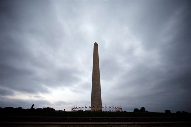 Clouds are seen above the Washington Monument as storms move into the area, Thursday, June 16, 2016 in Washington. A funereal atmosphere has taken hold in government offices in the U.S. capital, where numerous federal employees describe mournful, even tearful, scenes among dejected co-workers commiserating about Donald Trump's impending presidency. THE CANADIAN PRESS/AP, Alex Brandon