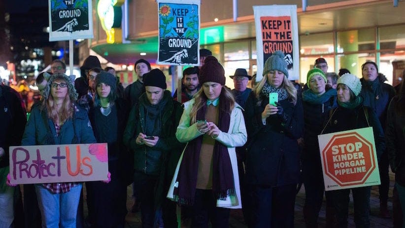 People listen during a protest against the Kinder Morgan Trans Mountain Pipeline expansion project, in Vancouver, B.C., on Tuesday November 29, 2016. Prime Minister Justin Trudeau approved the $6.8-billion project that will nearly triple the capacity of the pipeline that carries crude oil from near Edmonton to the Vancouver area to be loaded on tankers and shipped overseas. THE CANADIAN PRESS/Darryl Dyck