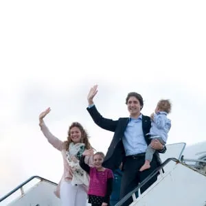 Canadian Prime Minister Justin Trudeau, Hadrien, Ella-Grace and his wife Sophie Gregoire-Trudeau board a government plane Saturday, November 28, 2015. (Adrian Wyld/CP)