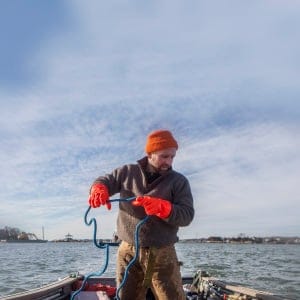 Bren Smith, GreenWave Executive Director and owner of Thimble Island Ocean Farm works with apprentice, Nick Pastore, on the coast of Branford, Connecticut. (Photograph by Johnathon Henninger)