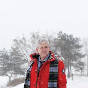 NDP leadership hopeful Charlie Angus in a snow storm, with the shadow Parliament Hill behind him, in Gatineau December 17, 2016. (Photograph by Blair Gable)