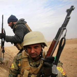 Shiite fighters from the Hashed al-Shaabi (Popular Mobilisation) paramilitary units advance towards the village of Shwah, south of the city of Tal Afar on the western outskirts of Mosul, on December 13, 2016, during an ongoing operation against Islamic State (IS) group jihadists. (Ahmed Al-Rubaye/AFP/Getty Images)