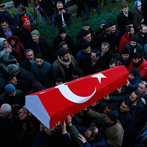 Mourners carry the Turkish flag-draped coffin of Yunus Gormek, 23, one of the victims of the attack at a nightclub on New Year's Day, during the funeral in Istanbul, Monday, Jan. 2, 2017. An assailant armed with a long-barrelled weapon, opened fire at the nightclub in Istanbul's Ortakoy district during New Year's celebrations, killing dozens of people and wounding many others. (Emrah Gurel/AP/CP)