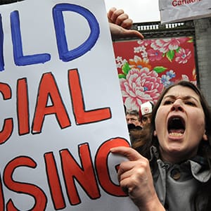 People shout slogans for social housing as they attend an anti-Olympics rally in central Vancouver, BC, Canada on February 12, 2010. (Yuri Kadobnov/AFP/Getty Images)