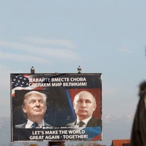 A woman passes a billboard showing a pictures of US president-elect Donald Trump and Russian President Vladimir Putin in Danilovgrad, Montenegro, November 16, 2016. (Stevo Vasiljevic/Reuters)