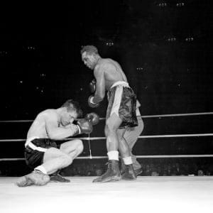 Canadian challenger Yvon Durelle is down in 11th round of Light-Heavyweight title fight just before losing to champion Archie Moore in Montreal, Quebec, Canada, Dec. 10, 1958. (AP/CP)
