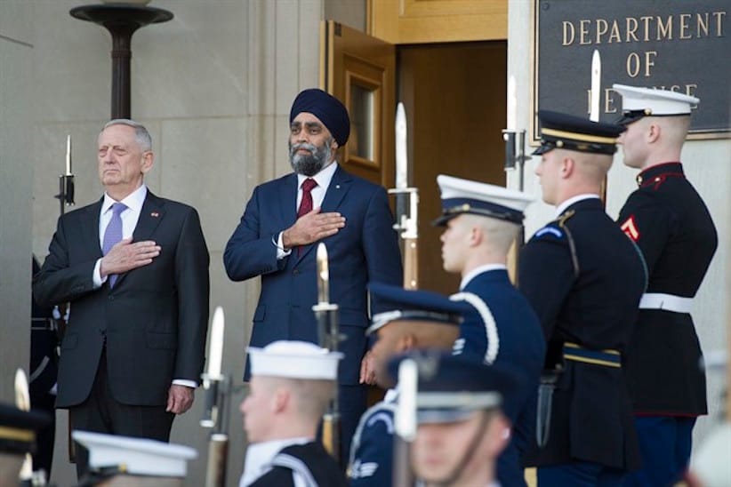 Defense Secretary Jim Mattis and Canadian Defense Minister Harjit Sajjan stand for the National Anthem of the United States during an Honor Cordon at the Pentagon., Monday, Feb. 6, 2017. (AP Photo/Cliff Owen)