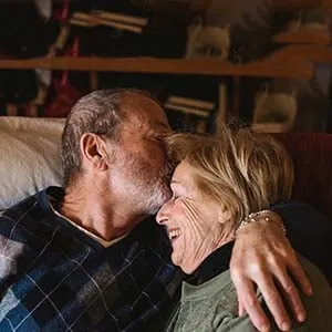 Happy and playful senior couple together at home. (Simone Becchetti/Stocksy)
