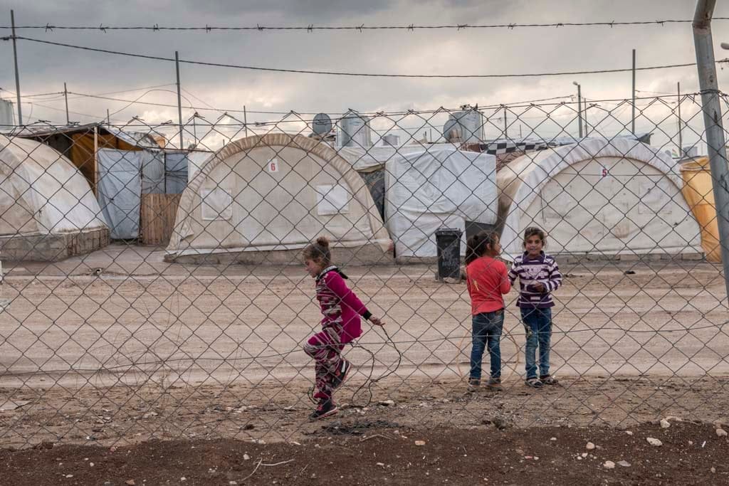 Children play within the Duhok refugee camp in Iraq (Photograph by
Peter Bregg)