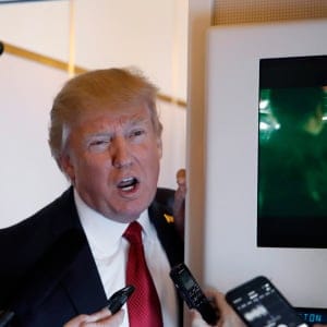 President Donald Trump speaks with reporters on Air Force One while in flight from Andrews Air Force Base, Md., to Palm Beach International Airport, Fla., Thursday, April 6, 2017. (Alex Brandon/AP/CP)