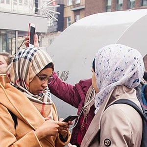 Muslim women check their cell phones outside Concordia University in Montreal, Wednesday, March 1, 2017, following a bomb threat. (Graham Hughes/CP)